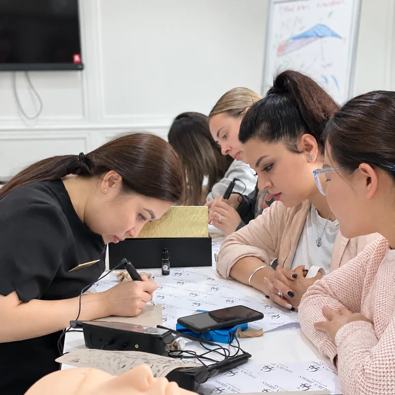 Tina correcting a student's brow mapping